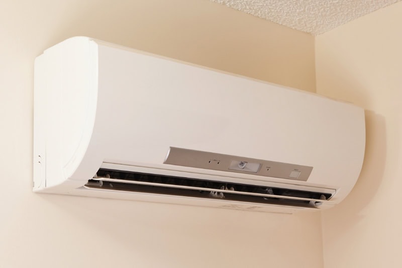 Why Are They Called Ductless Mini Splits? A wall-mount mini-split heating and air conditioning unit installed in a new house. A modern heat pump, this unit heats a house in winter and cools in the summer. This type of system eliminates ductwork which is a primary source of inefficiency in a conventional system making this about 30% more efficient. This particular unit has an eye sensor which pans the room looking for hot or cold spots and directs the airflow accordingly.
